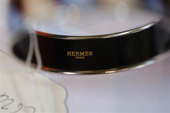A Hermes, Paris enamelled bangle with geometric pattern, with pouch and box.
